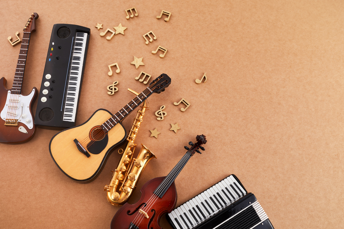 Happy World Music Day. Musical Instruments on Brown Background.